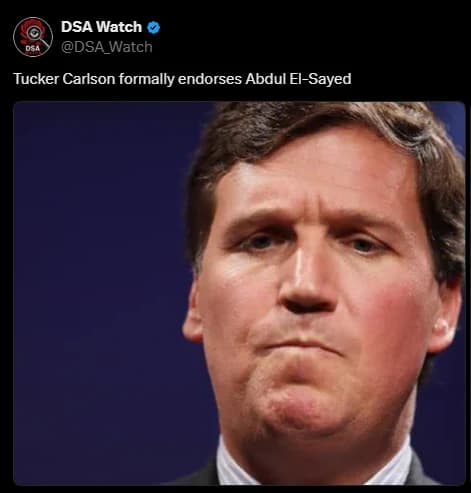 A close-up photograph of Tucker Carlson's face against a dark blue background.